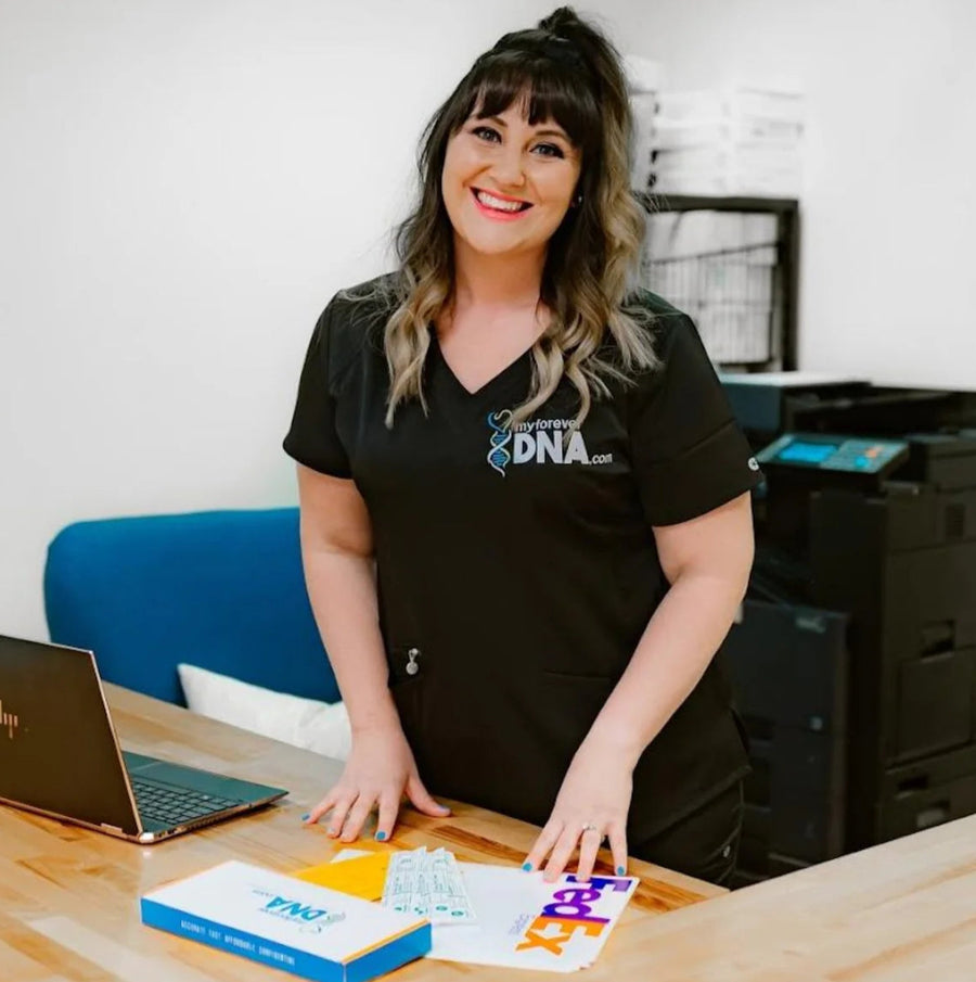 Smiling DNA specialist at My Forever DNA preparing test kits with FedEx return envelopes, ensuring fast and accurate service.