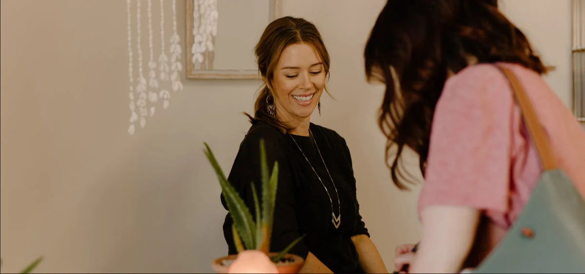 Smiling DNA specialist assisting customer at My Forever DNA's Omaha clinic, known for personalized and compassionate service.