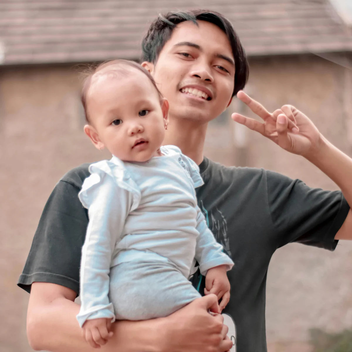 Man holding baby, representing My Forever DNA’s Aunt or Uncle (Avuncular) Home DNA Test to confirm biological family relationships.