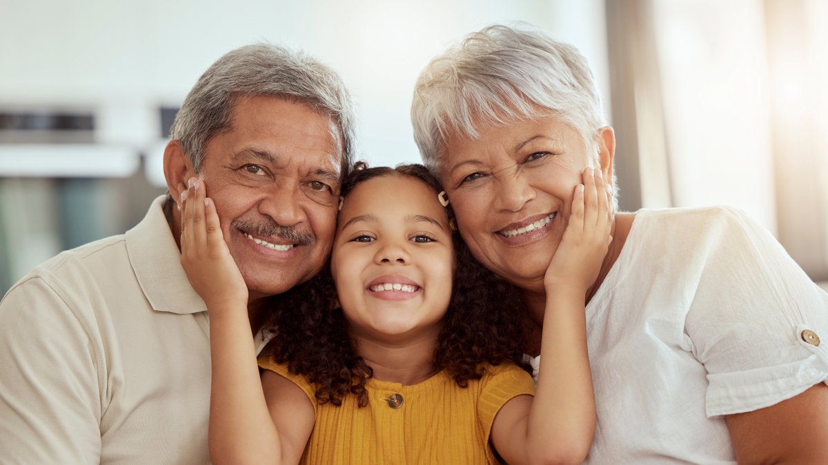 A joyful multigenerational family portrait, featuring a granddaughter with her grandparents, symbolizing the connections revealed through My Forever DNA's grandparent DNA testing.