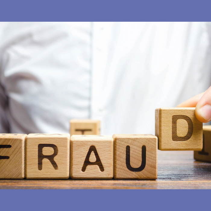 Wooden blocks spelling "FRAUD" being manipulated by a hand, symbolizing the exposure and implications of paternity fraud. Highlights the importance of accurate DNA testing to uncover the truth.