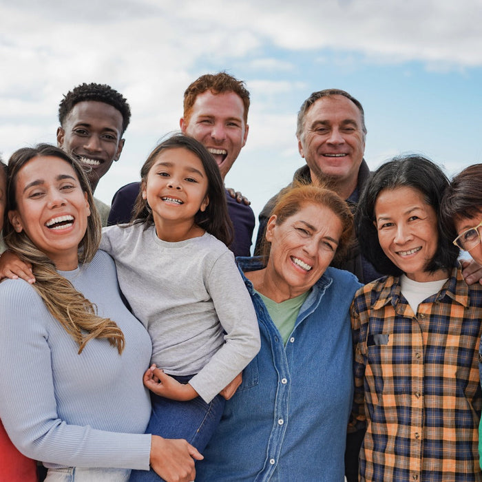 Smiling people of different ages and backgrounds together, symbolizing one human family at My Forever DNA.