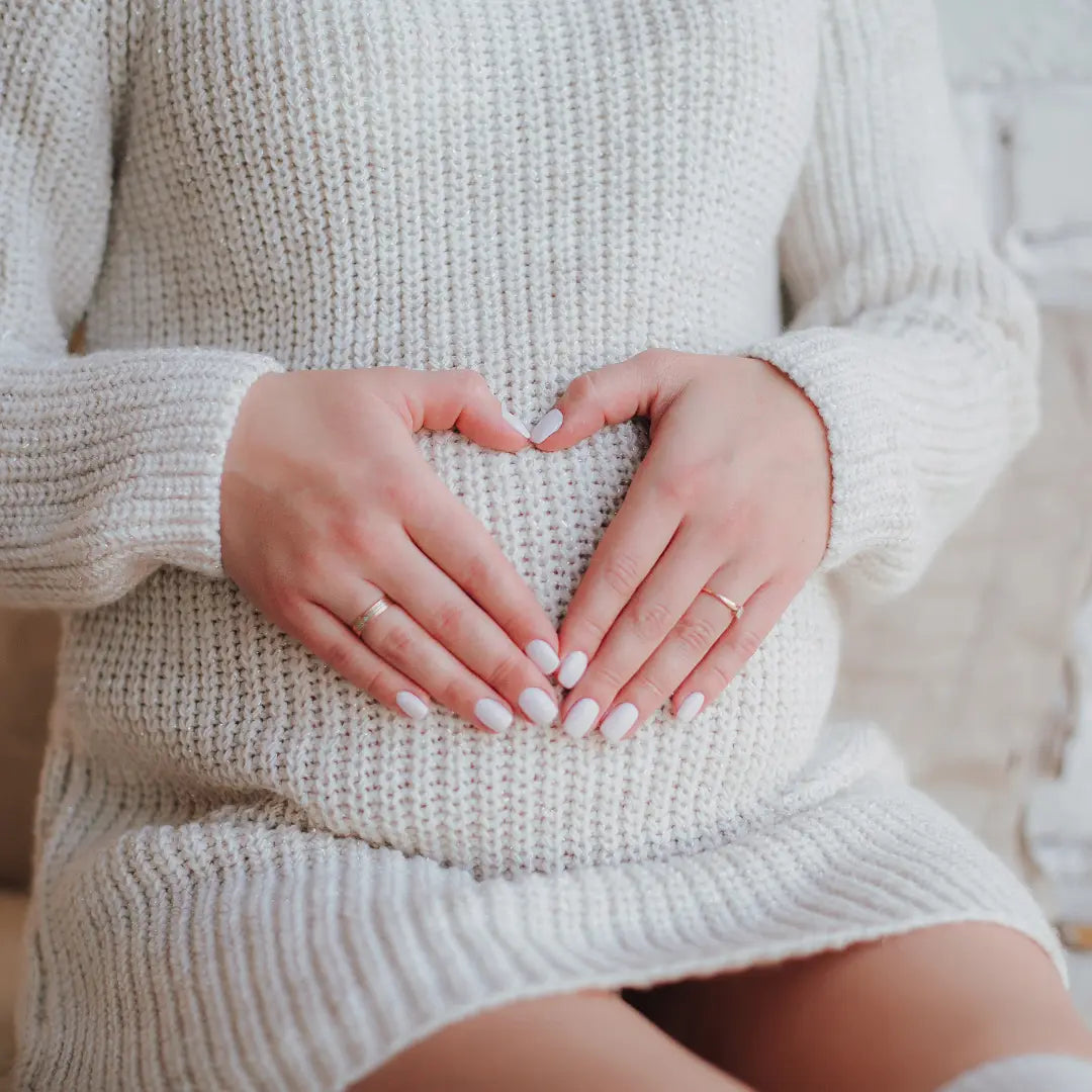 Pregnant woman holding belly representing non-invasive prenatal paternity DNA testing in Omaha Nebraska