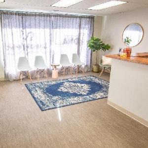 A serene and welcoming waiting area at My Forever DNA, featuring stylish chairs and a calming decor, reflecting their commitment to providing a comfortable client experience.