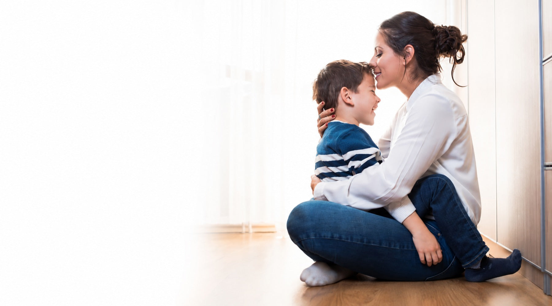 Mother and child sharing a warm loving moment at home in a bright hero image for My Forever DNA private at home DNA testing services.