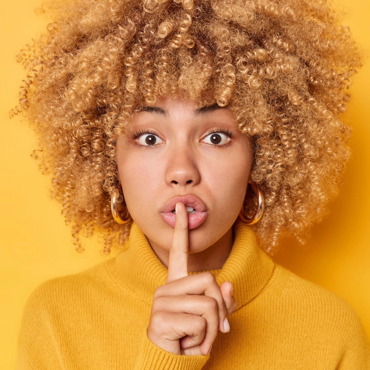 Close-up of woman making a “shh” gesture, symbolizing discreet DNA testing with confidential sample options | My Forever DNA