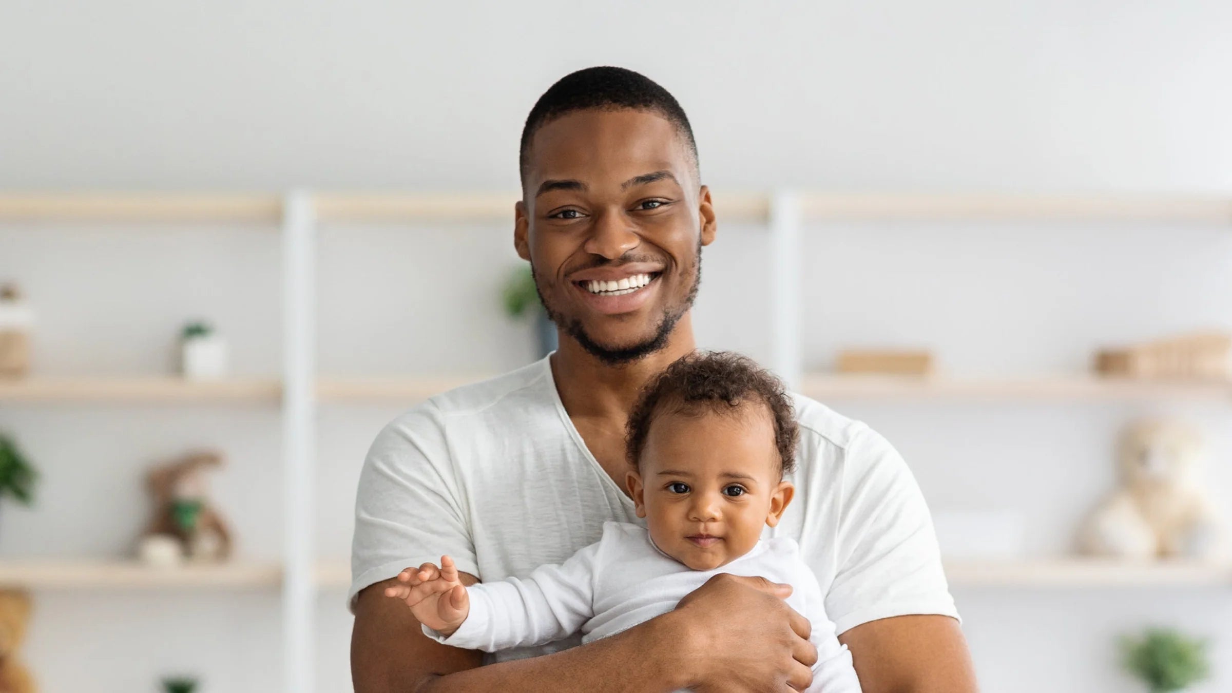 Smiling father holding baby, representing My Forever DNA's accurate, private, and trusted at-home paternity DNA testing service.