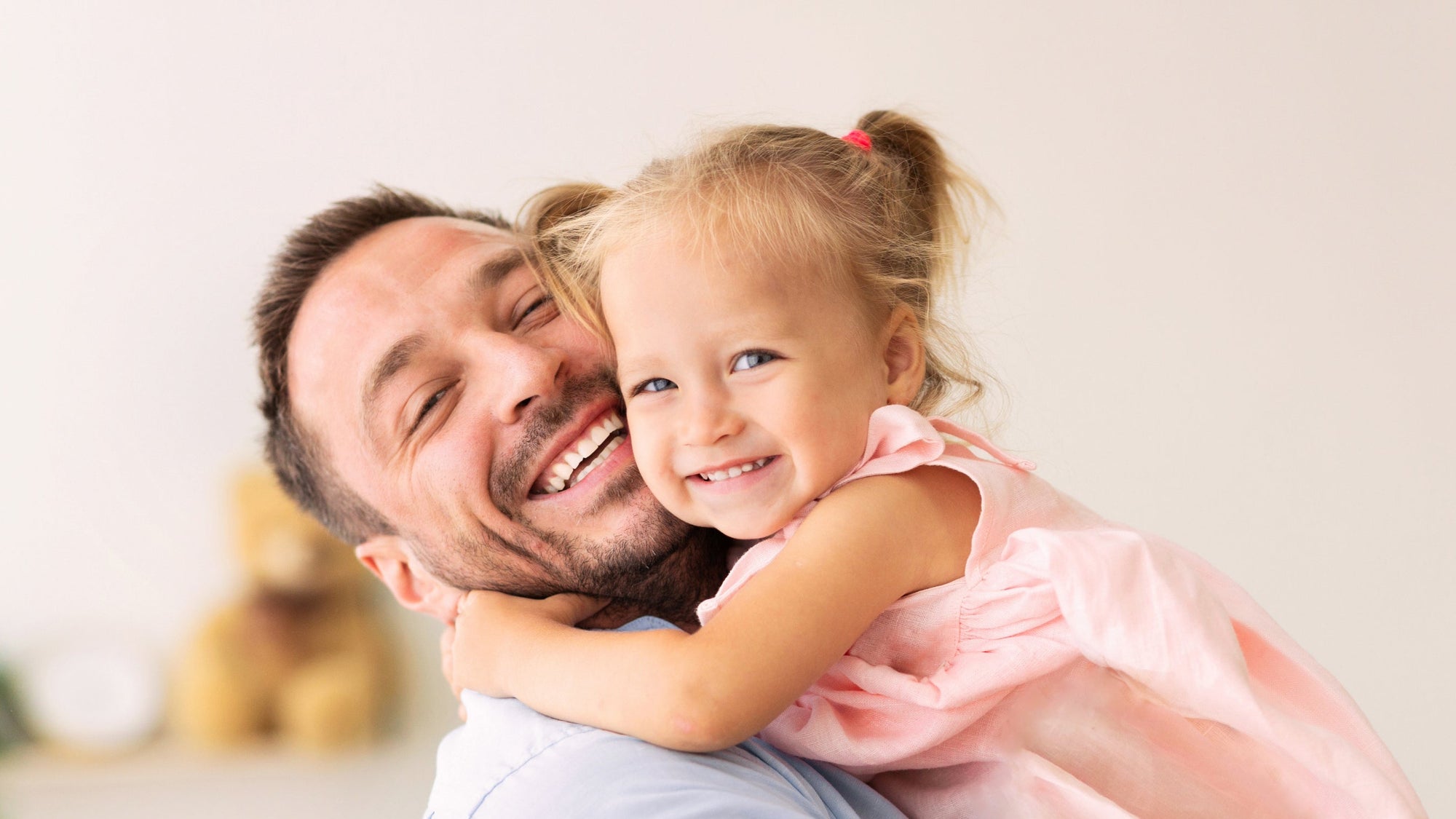 Smiling father holding his young daughter, symbolizing the love and reassurance that comes with accurate home paternity DNA testing from My Forever DNA.