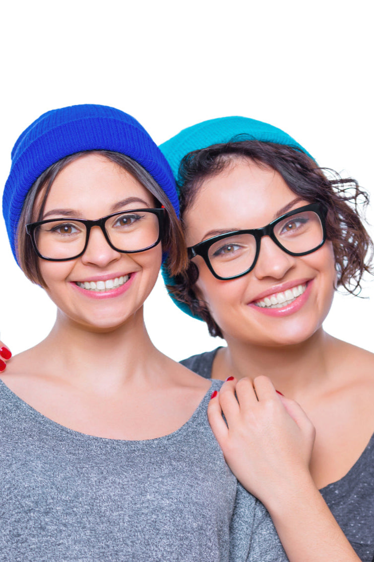 Two smiling women wearing glasses and beanies representing accurate sibling DNA testing with My Forever DNA